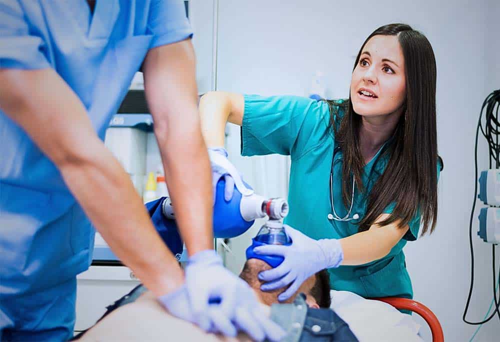 Doctors resuscitating patient in emergency room