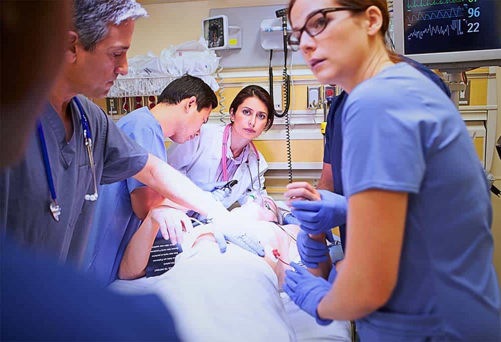 Doctors performing work-up in emergency room